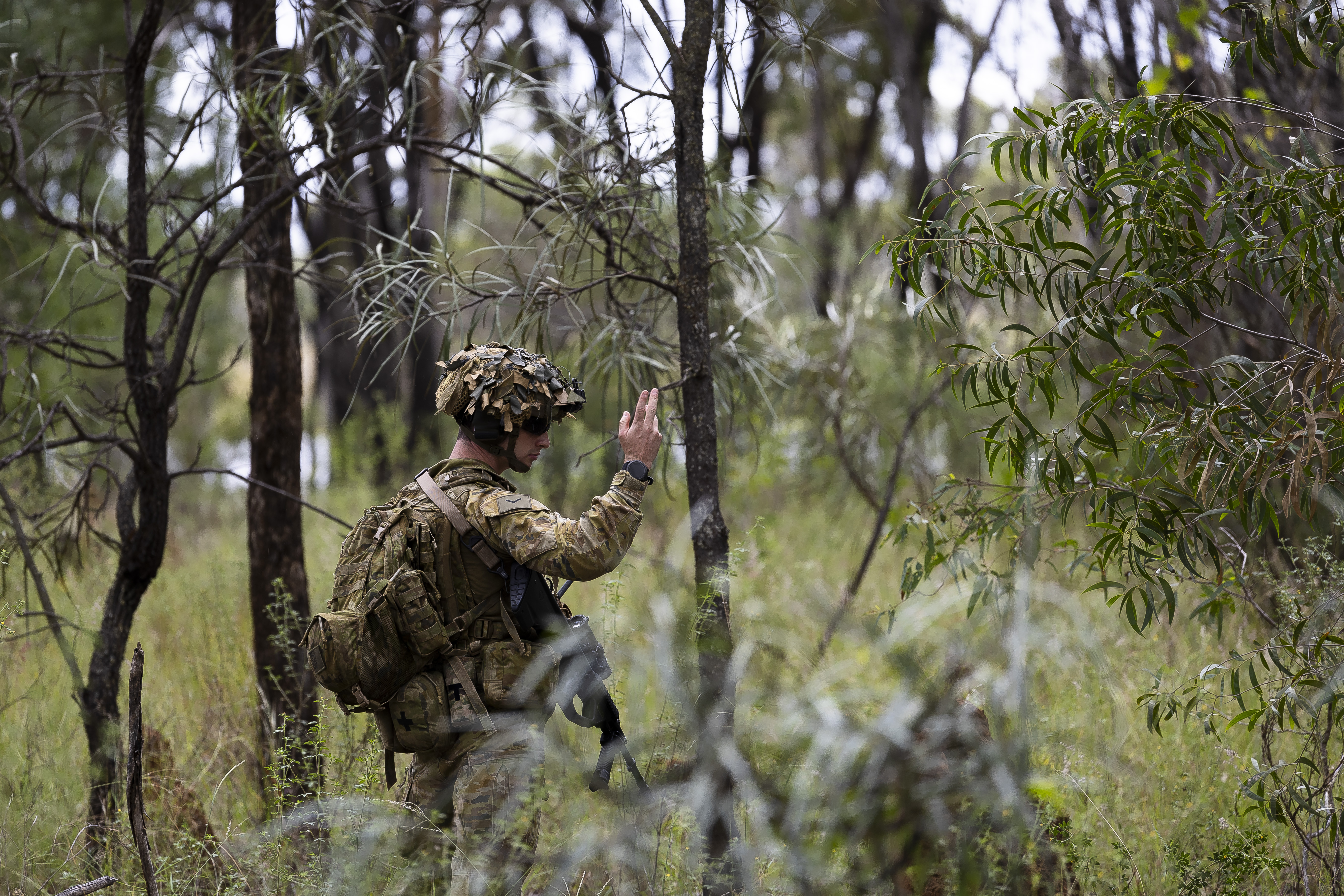 ADF member moving through bushland during field activity